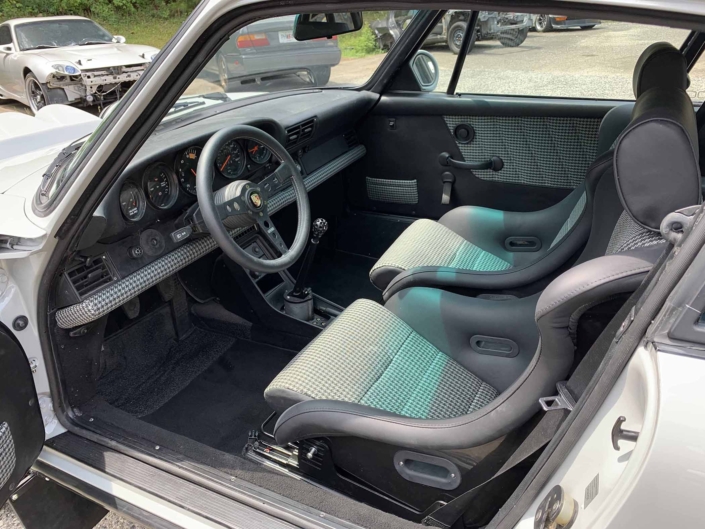 front seating of a rear view of a custom 1986 Porsche 911 Carrera with Chalk exterior