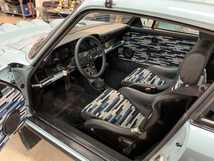 Custom Built 1988 Porsche 930 Turbo with Meissen Blue exterior and Carrera fabric interior with the door open showcasing custom interior