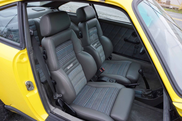front seating in a Custom Built 1988 Porsche 911 Carrera with Cadmium Yellow exterior and Opel fabric interior
