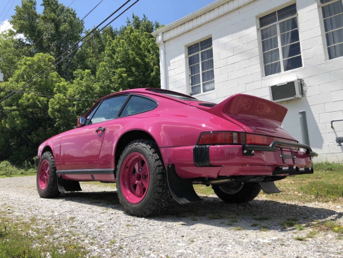 3/4 rear view of a Custom Built 1988 Porsche 911 Carrera with Ruby Stone Exterior and Mercedes Fabric Interior