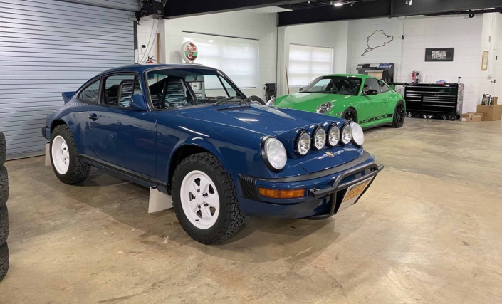 Custom Built 1987 Porsche 911 Carrera with Aga Blue exterior and Carrera fabric interior parked in a garage