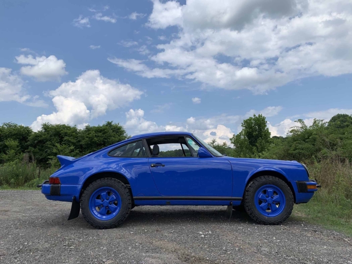 side view of a Custom Built 1988 Porsche 911 Carrera in Acid Blue with Dog fabric interior
