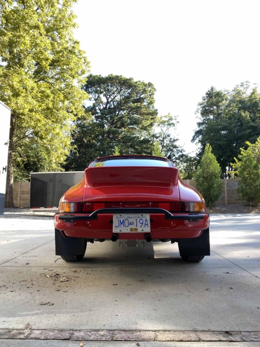 rear view of a Custom Built 1987 Porsche 911 Carrera with Cherry Red exterior and VW retro interior