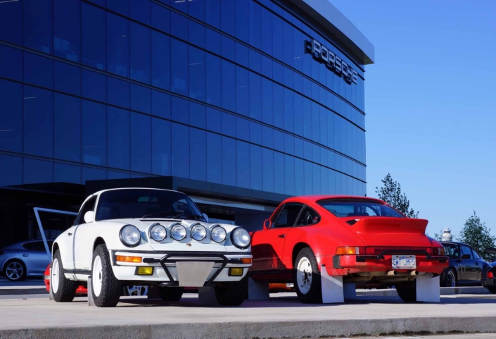 Custom Built Carrera White 1989 911 Carrera parked in front of of the Porsche Building