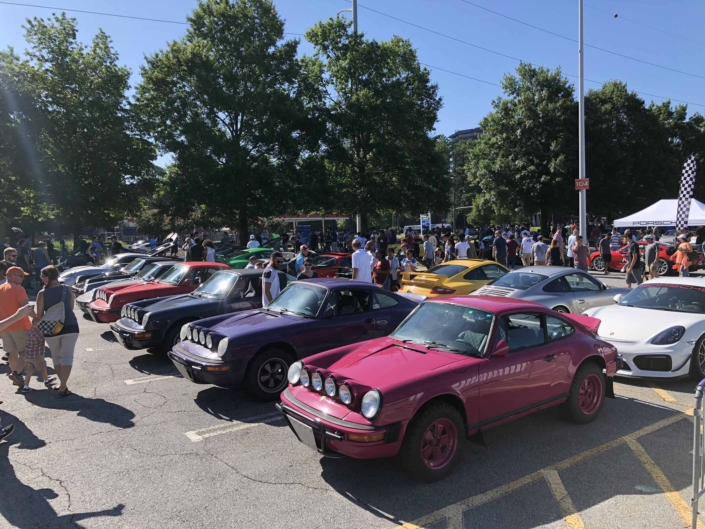 Custom Built 1988 Porsche 911 Carrera with Ruby Stone Exterior and Mercedes Fabric Interior parked outside with other custom built porsche's