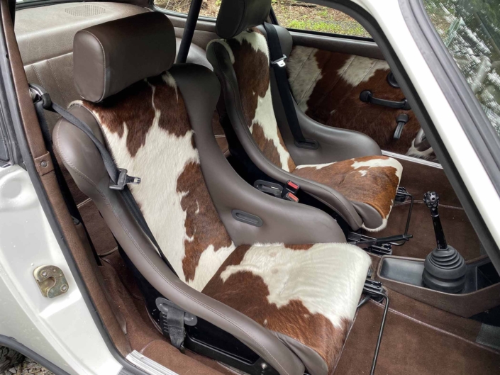 front seating on a Custom Built 1981 Porsche 911 SC with Grand Prix White exterior and Cow Interior