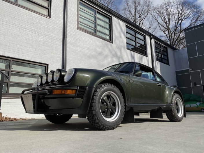 3/4 front view of a Custom Built 1986 Porsche 930 Turbo with Oak Green Metallic Exterior and Porsche tartan interior