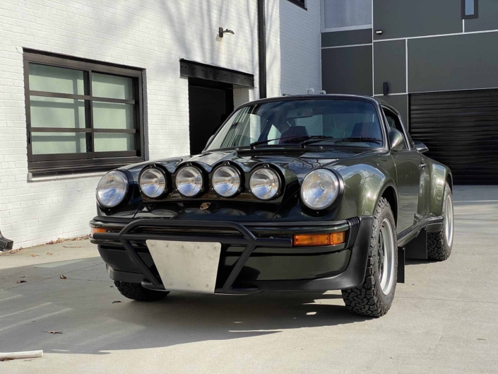 freshly cleaned front view of a Custom Built 1986 Porsche 930 Turbo with Oak Green Metallic Exterior and Porsche tartan interior