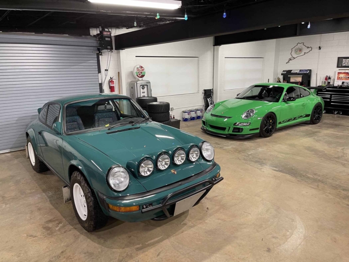 Custom Built 1974 Porsche 911 in Smyrna Green with Fiat fabric parked in front of the garage