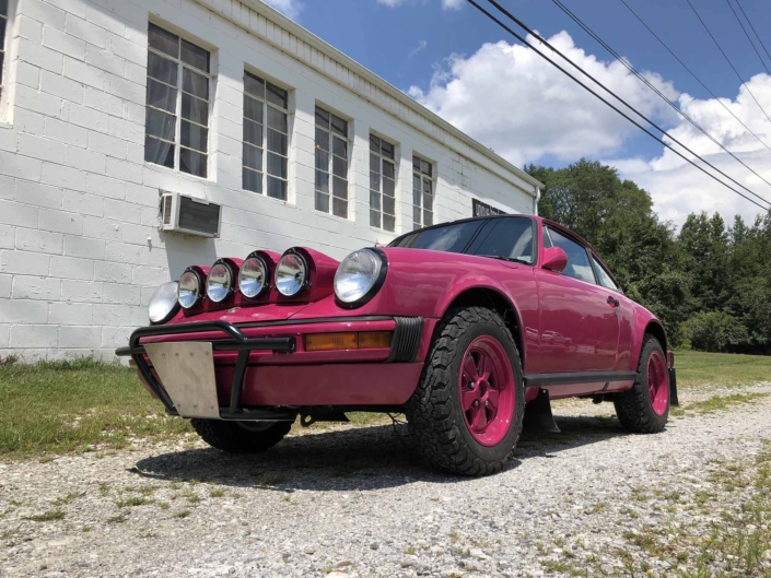 Custom Built 1988 Porsche 911 Carrera with Ruby Stone Exterior and Mercedes Fabric Interior parked in front of a house on a driveway