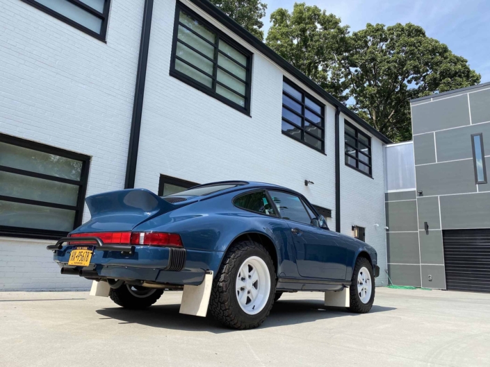 3/4 rear view of a Custom Built 1987 Porsche 911 Carrera with Aga Blue exterior and Carrera fabric interior