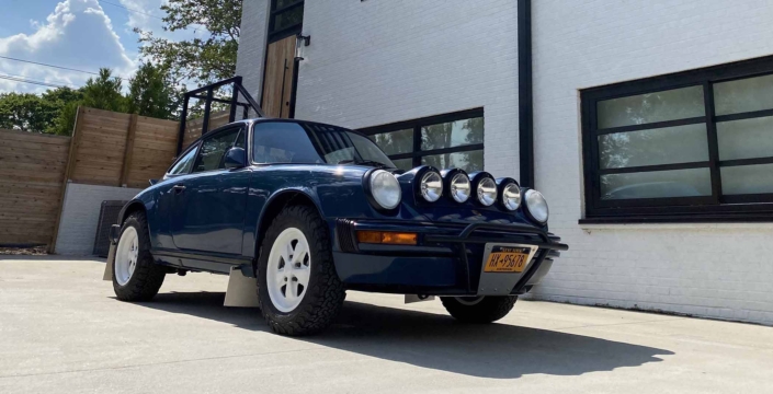 Custom Built 1987 Porsche 911 Carrera with Aga Blue exterior and Carrera fabric interior parked in front of a modern house