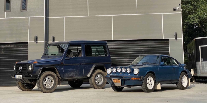 Custom Built 1987 Porsche 911 Carrera with Aga Blue exterior and Carrera fabric interior parked next to a g wagon