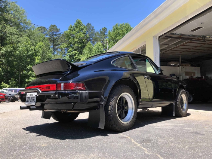 3/4 rear view of a Custom Built 1986 Porsche 911 Carrera with Shwartz Exterior and Mercedes G Fabric Interior