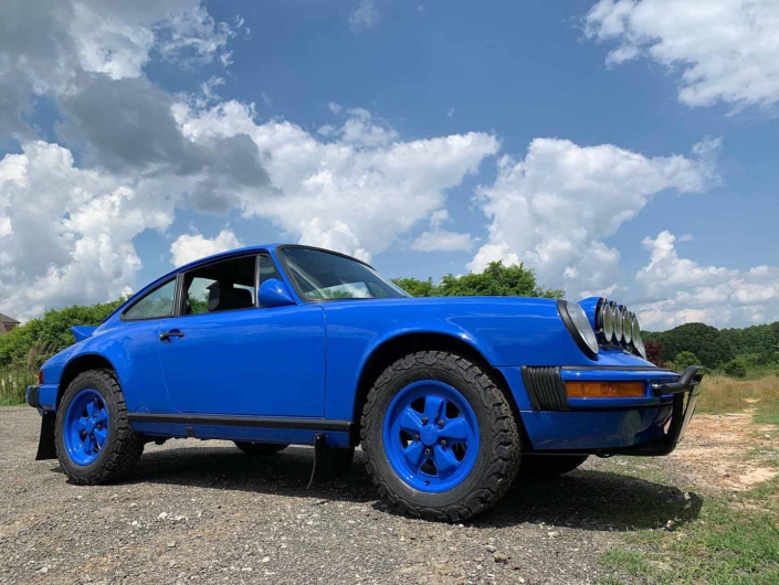 ground view of a Custom Built 1988 Porsche 911 Carrera in Acid Blue with Dog fabric interior