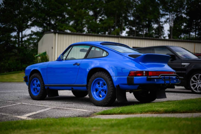 3/4 rear view of Leh Keen's Custom Built 1988 Porsche 911 Carrera in Acid Blue with Dog fabric interior