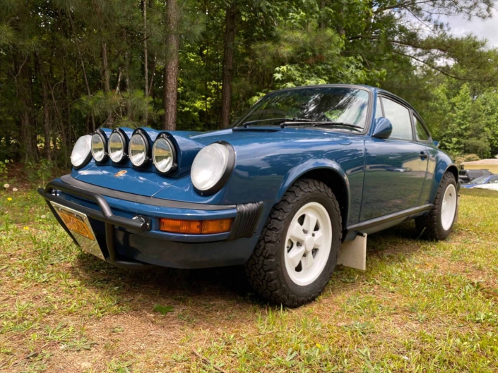 3/4 front view of a Custom Built 1987 Porsche 911 Carrera with Aga Blue exterior and Carrera fabric interior