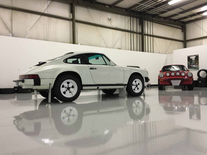 Custom Built Carrera White 1989 911 Carrera with Porsche Tartan Interior parked in a garage