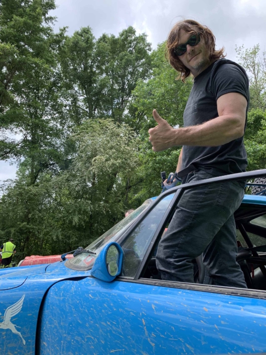 man giving thumbs up standing in a Custom Built 1980 Porsche 911 SC in Riviera Blue