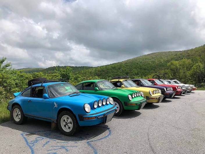 Custom Built 1980 Porsche 911 SC in Riviera Blue parked in a lineup of custom porsches