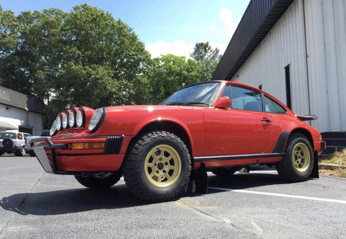 side view of Custom Built 1986 Porsche 911 Carrera in Indian Red with Porsche Studiocheck Interior