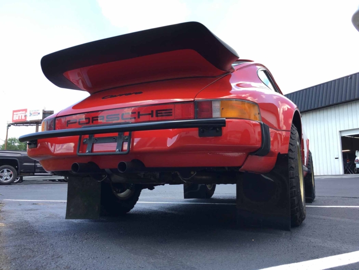 rear view of a Custom Built 1986 Porsche 911 Carrera in Indian Red with Porsche Studiocheck Interior