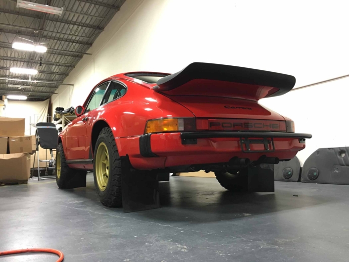 rear view of Custom Built 1986 Porsche 911 Carrera in Indian Red with Porsche Studiocheck Interior