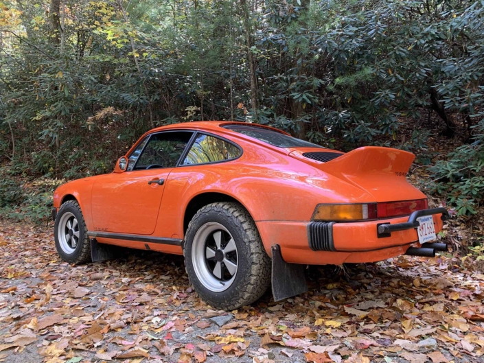 rear view of a Custom built 1987 Porsche 911 Carrera with Continental Orange exterior and VW tartan interior