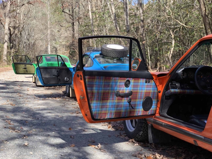 Custom built 1987 Porsche 911 Carrera with Continental Orange exterior and VW tartan interior with the door open showcasing the interior