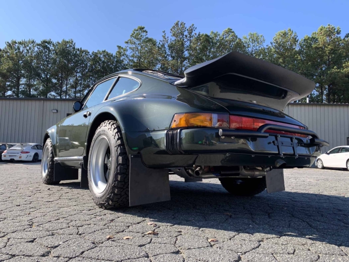 3/4 rear view of a Custom Built 1986 Porsche 930 Turbo with Oak Green Metallic Exterior and Porsche tartan interior