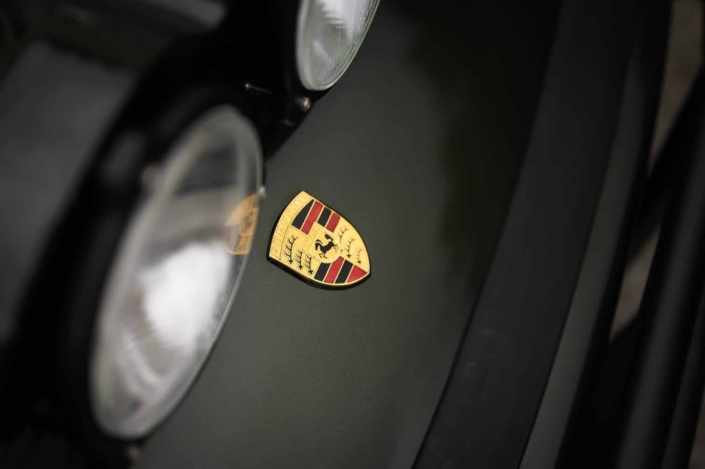 porsche emblem on a Custom Built 1986 Porsche 930 Turbo with Oak Green Metallic Exterior and Porsche tartan interior