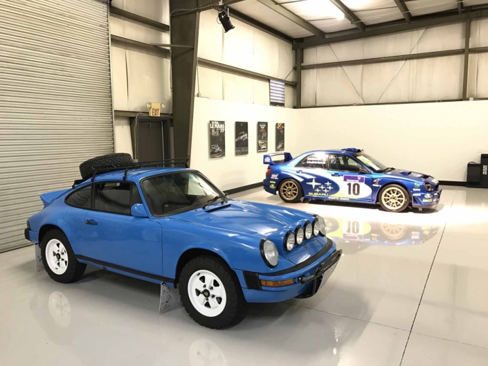 Custom Built 1980 Porsche 911 SC in Riviera Blue with blue and brown basket weave interior parked in a garage