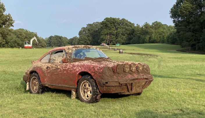 Custom Built 1981 Guards Red Porsche 911 SC covered in dirt from off roading