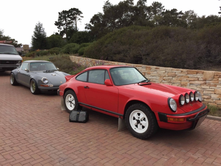 Custom Built 1981 Guards Red Porsche 911 SC parked on brick pavement